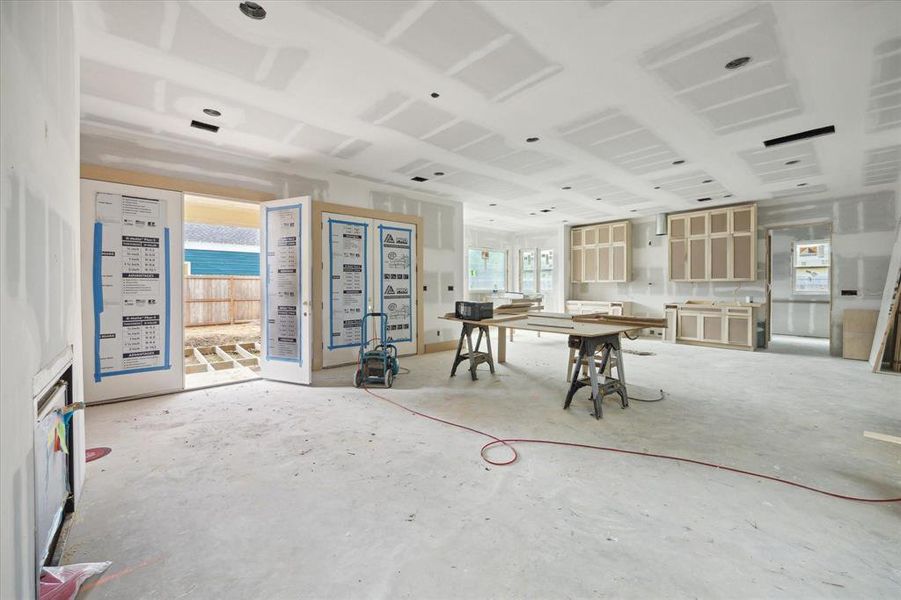 A view from the living room highlights the seamless flow into the soon-to-be kitchen and breakfast nook. This open-concept layout creates a perfect blend of elegance and comfort, where every space feels connected and filled with natural light—ideal for both everyday living and stylish entertaining.