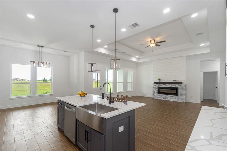 Open concept kitchen/living.  Quartz countertops and dark color custom wood kitchen island.