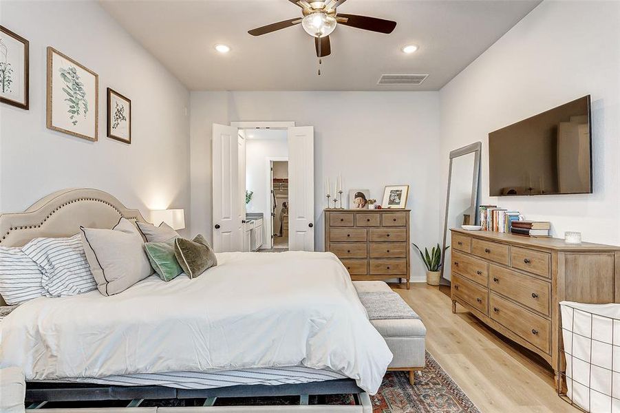 The beutiful French Oak floors, ceiling fan, neutral paint creates a suite that feels like a hotel room.