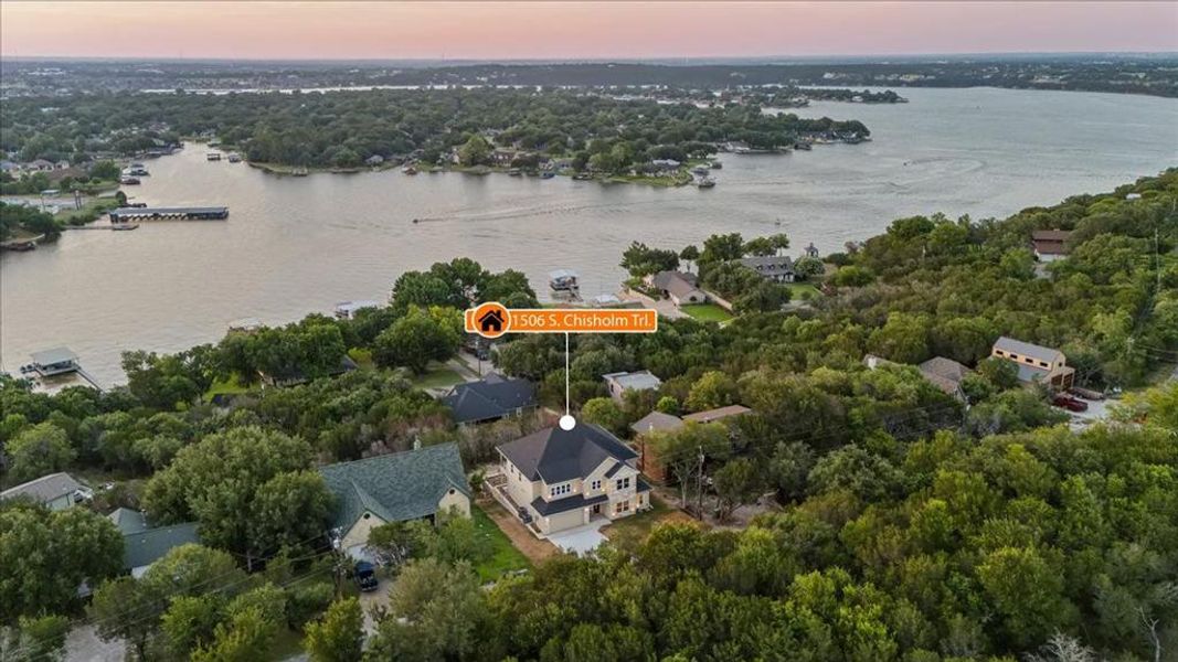 Aerial view at dusk featuring a water view