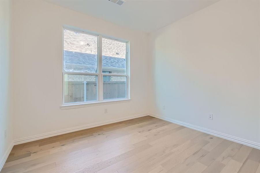 Spare room featuring light wood-type flooring