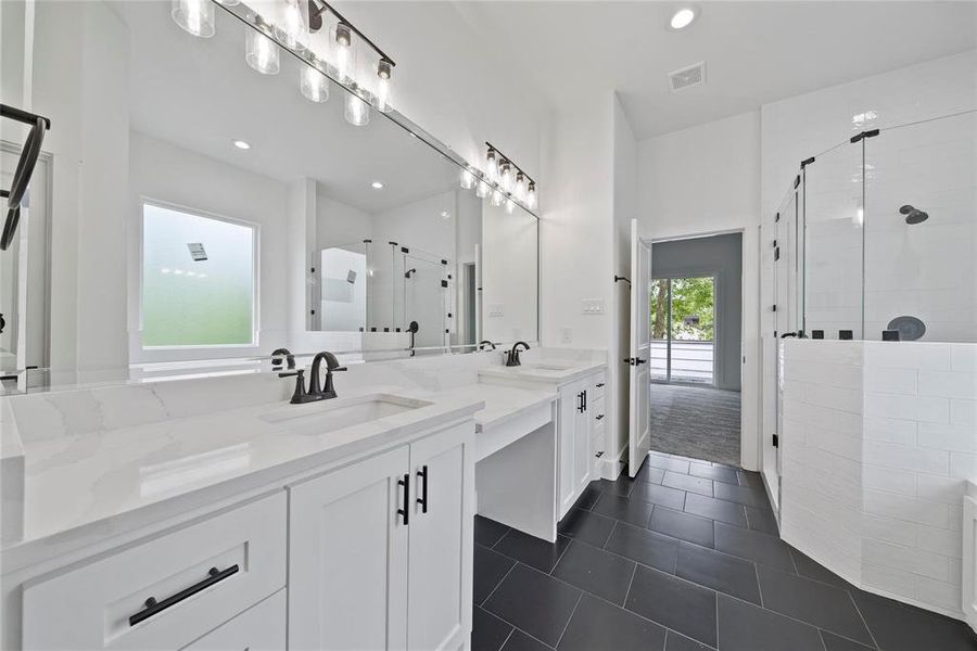 Primary bath with double vanities, oversized shower and soaking tub.