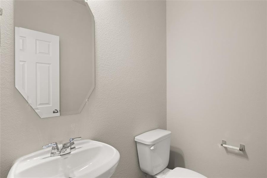 This charming home features a beautifully appointed half bath adjacent to the family room, perfect for welcoming guests and adding convenience to your daily life.