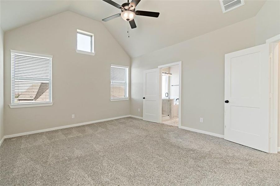 Primary Bedroom - Spacious high ceilings with natural light and ceiling fan