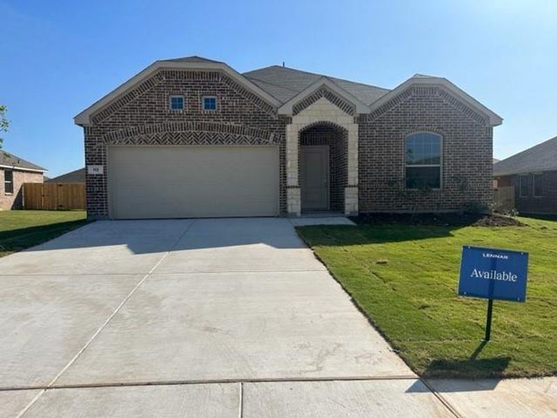 View of front facade with a front yard and a garage