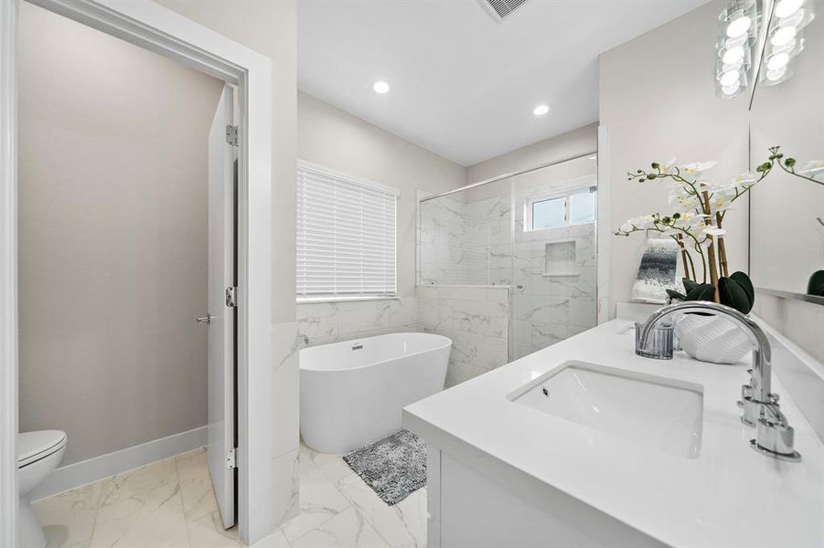 Primary Bathroom with Quartz counter tops, white cabinetry, framed mirror and more!