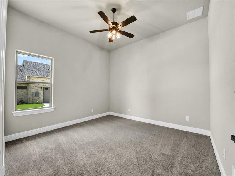 Unfurnished room with ceiling fan and carpet floors