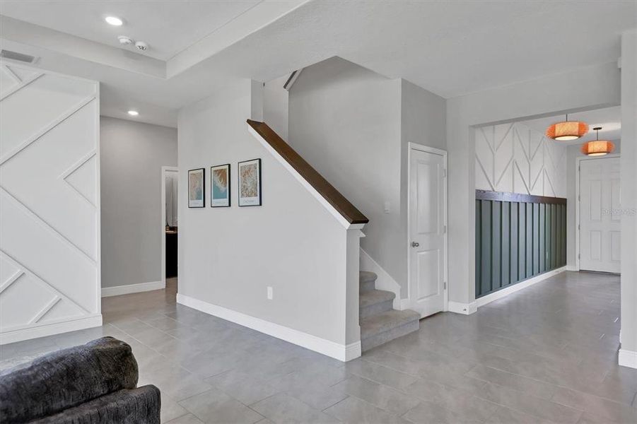 Stairs to the second floor have been enhanced with wood accent features.  There is also a large storage area to the right of the stairs!