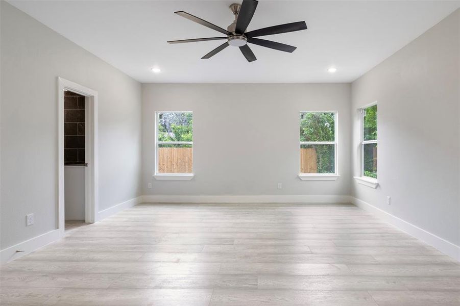 Spare room featuring ceiling fan and light hardwood / wood-style flooring