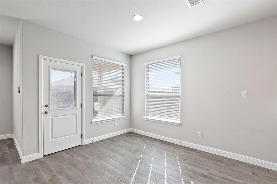 Empty room with light hardwood / wood-style floors