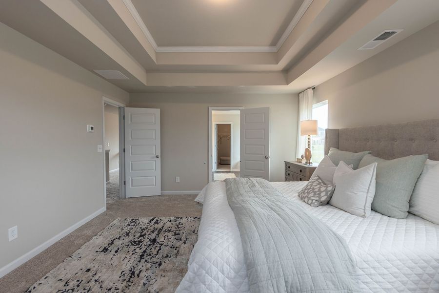 Spacious primary bedroom with large walk in closet and private bath