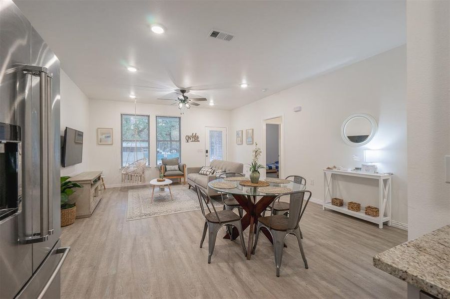 Dining room with ceiling fan and light hardwood / wood-style flooring