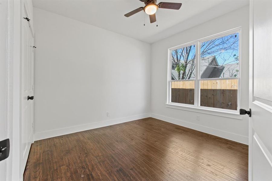 Spare room featuring ceiling fan and dark hardwood / wood-style flooring