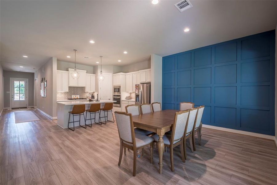 The dining room with a custom board and batten wall with accent color.