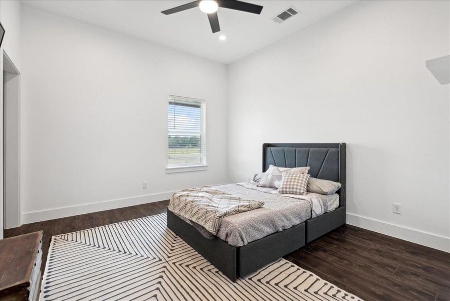 Bedroom featuring ceiling fan and dark hardwood / wood-style flooring