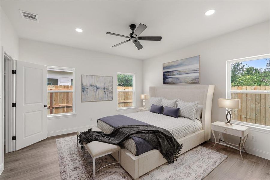 Bedroom featuring light hardwood / wood-style flooring and ceiling fan