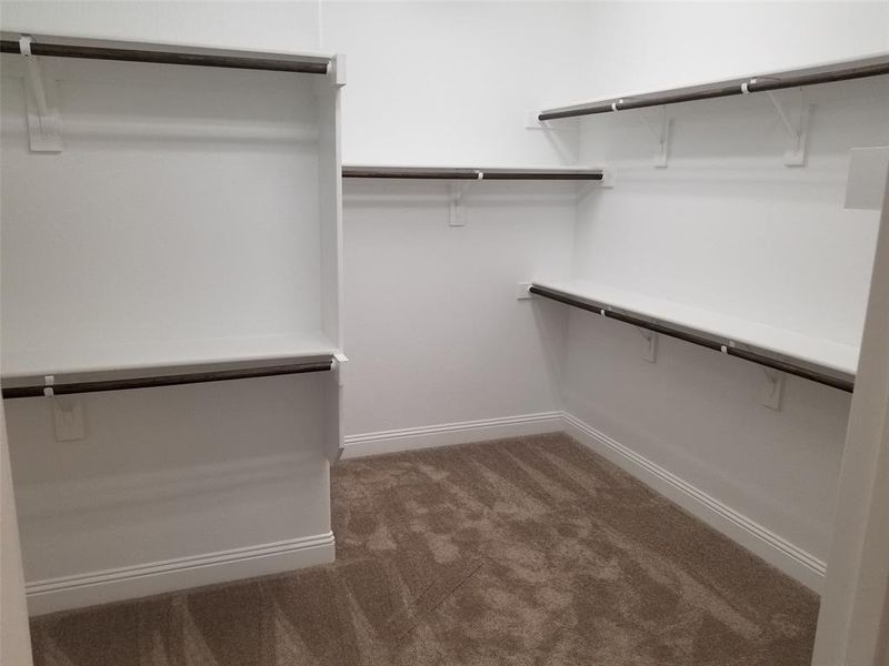 Master walk-in closet with lots of storage space.