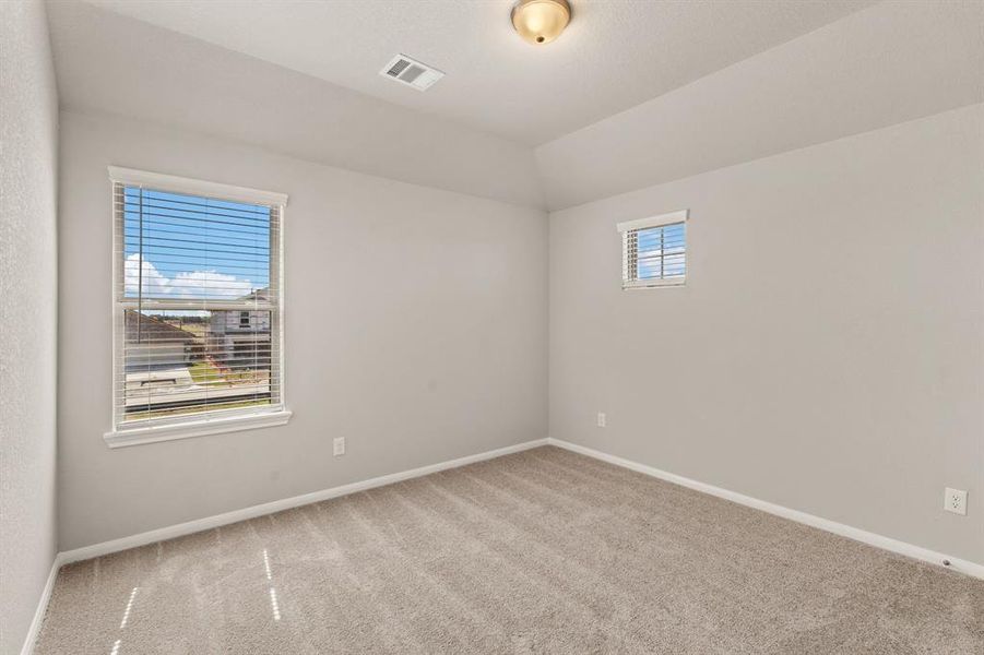 Your secondary bedroom features plush carpet, fresh paint, closet, and a large window that lets in plenty of natural lighting.