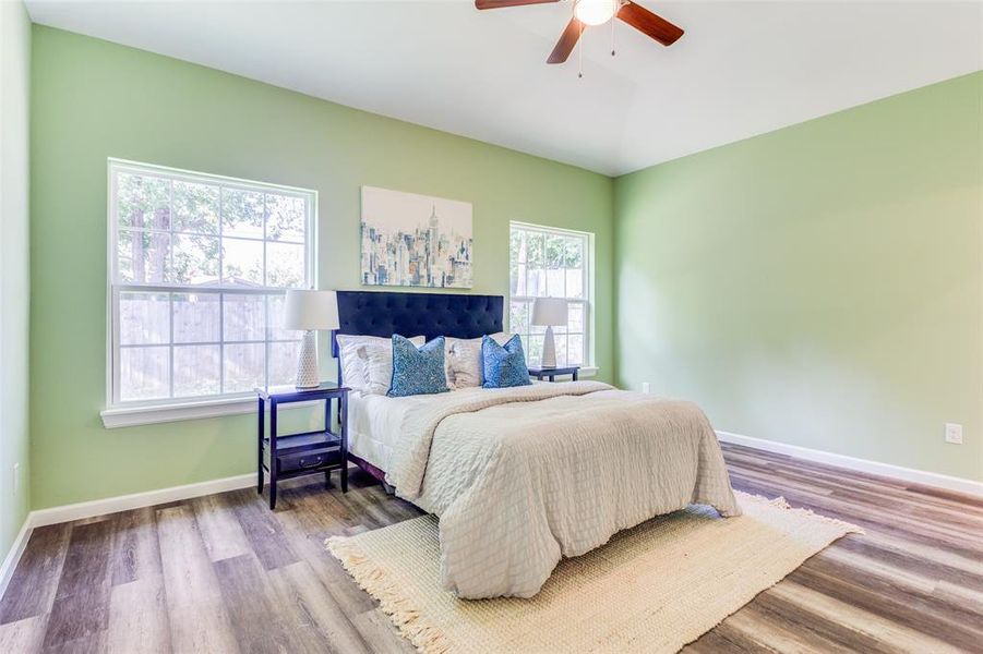 Bedroom featuring wood-type flooring and ceiling fan