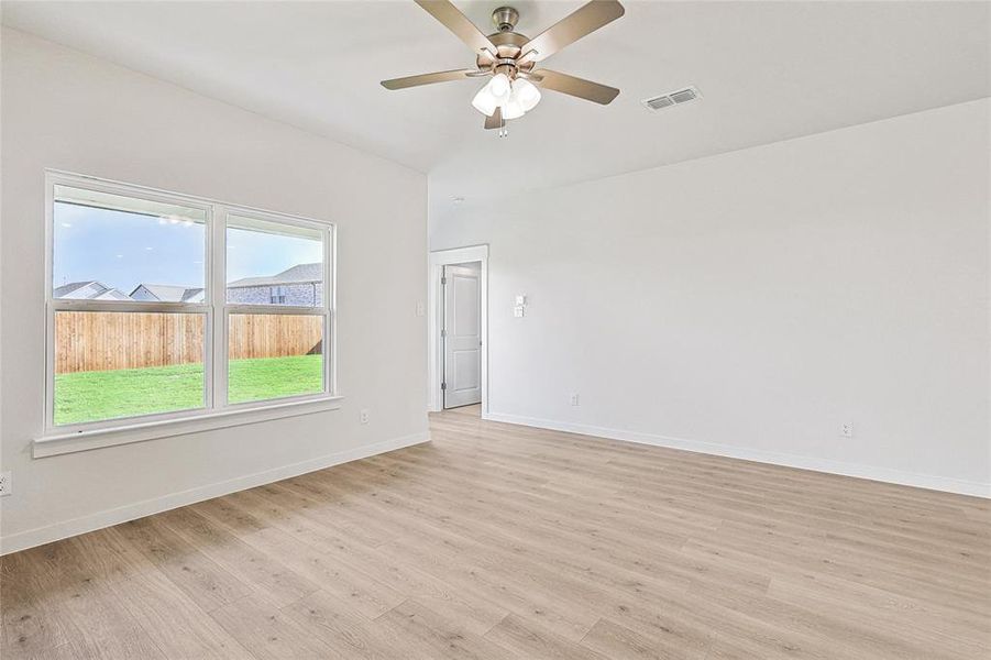 Unfurnished room with light wood-type flooring and ceiling fan