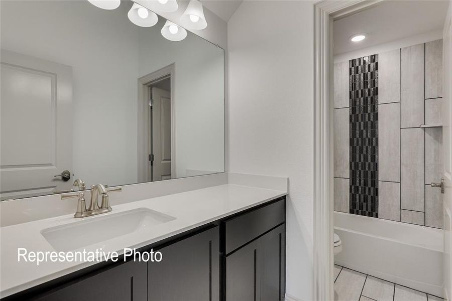 Full bathroom featuring toilet, tile flooring, shower / bathtub combination, and large vanity