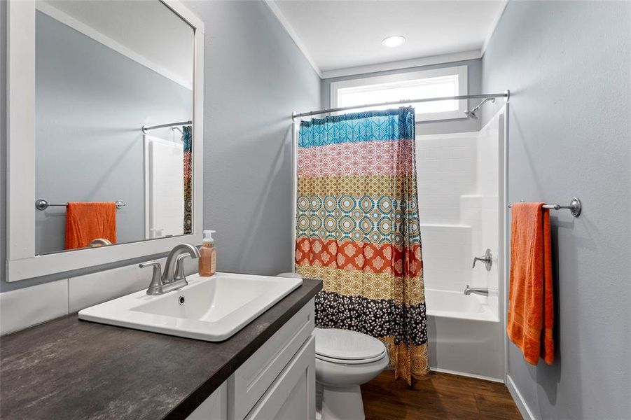 This bathroom that the 2nd and 3rd bedrooms share, as well as the guest offers, clean living with incredible lighting and counter space.