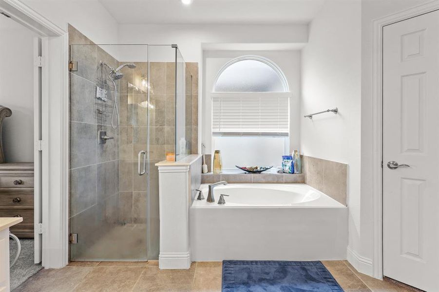 Bathroom with separate shower and tub and tile patterned flooring