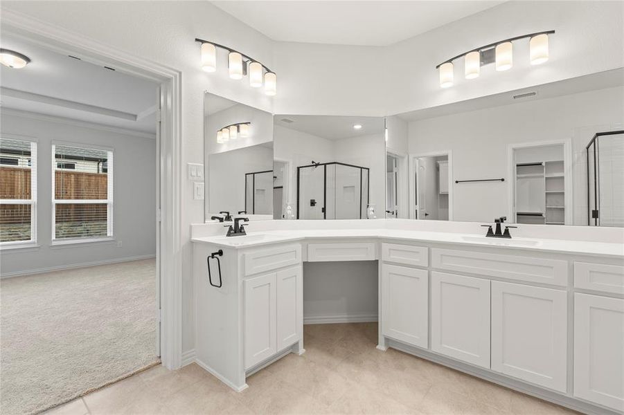 Bathroom with tile patterned floors and double sink vanity