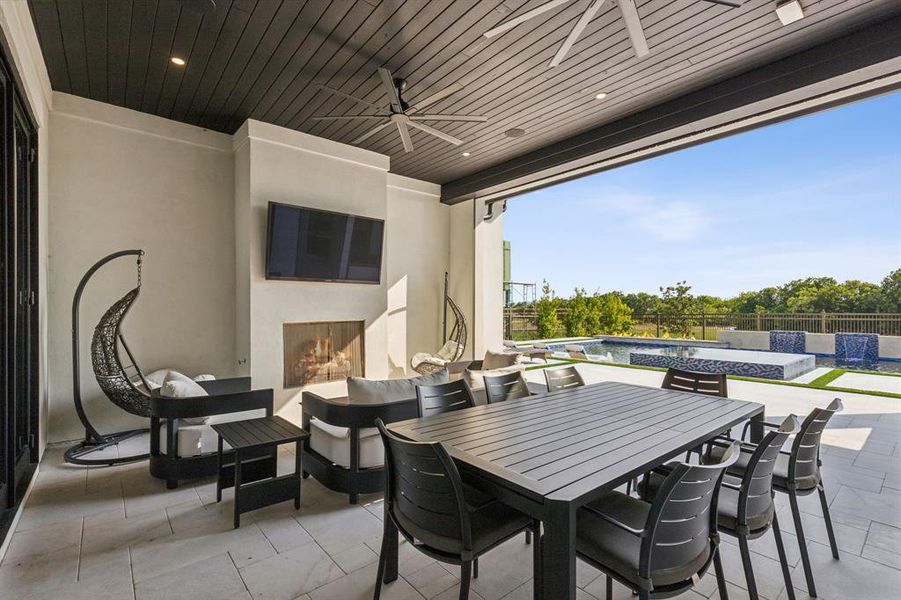 View of patio featuring ceiling fan and a fenced in pool