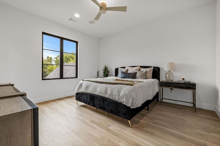 Bedroom featuring ceiling fan and light hardwood / wood-style floors