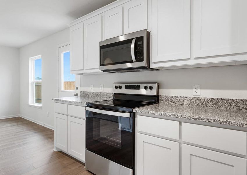 The kitchen of the Reed has beautiful, white wood cabinets.