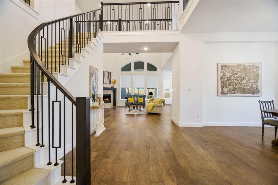 Entryway with dark wood-type flooring and a towering ceiling