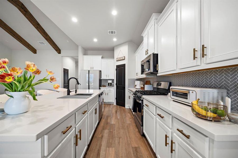 upgraded hardwood flooring and luxurious marble countertops throughout the home