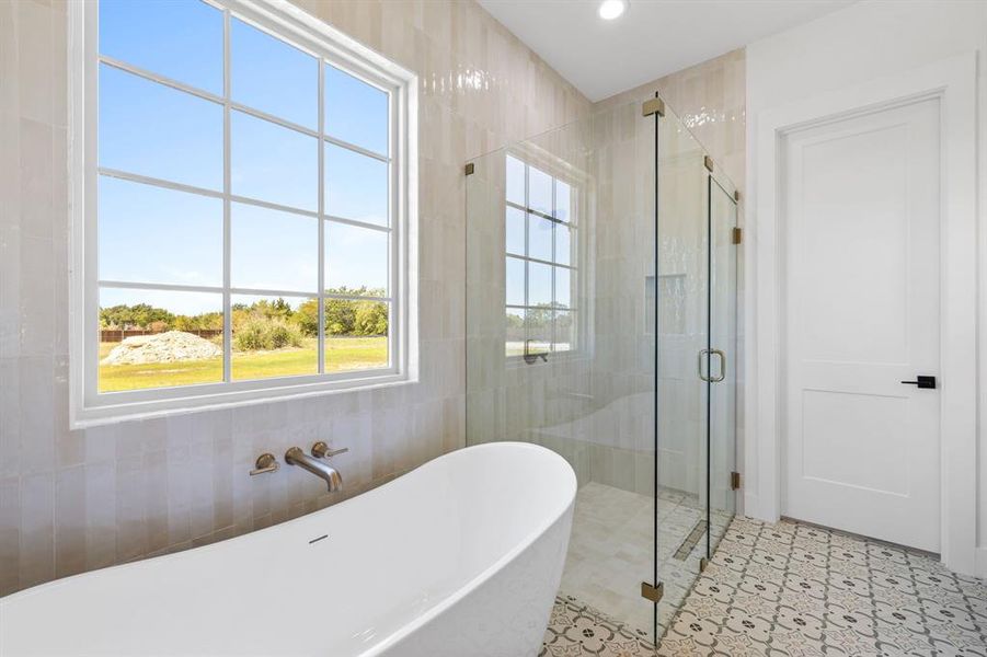 Bathroom featuring plus walk in shower and tile walls