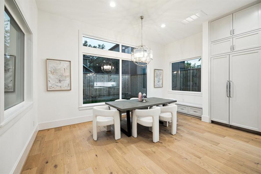 Breakfast area with built-in bench and storage drawers. There is also a Modern Chandelier finish in Polished Nickel.