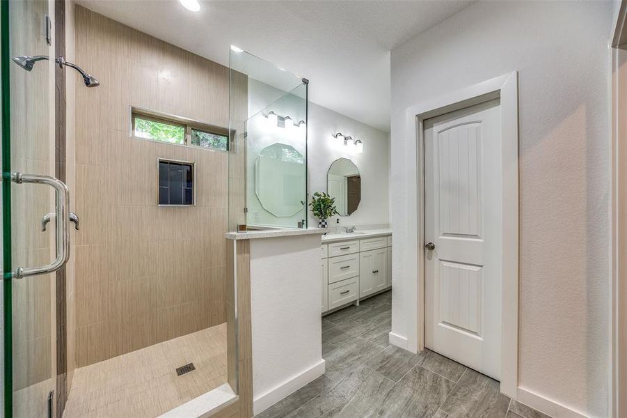 Bathroom with an enclosed shower and vanity