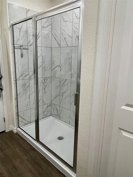 Large shower with corner shelf.