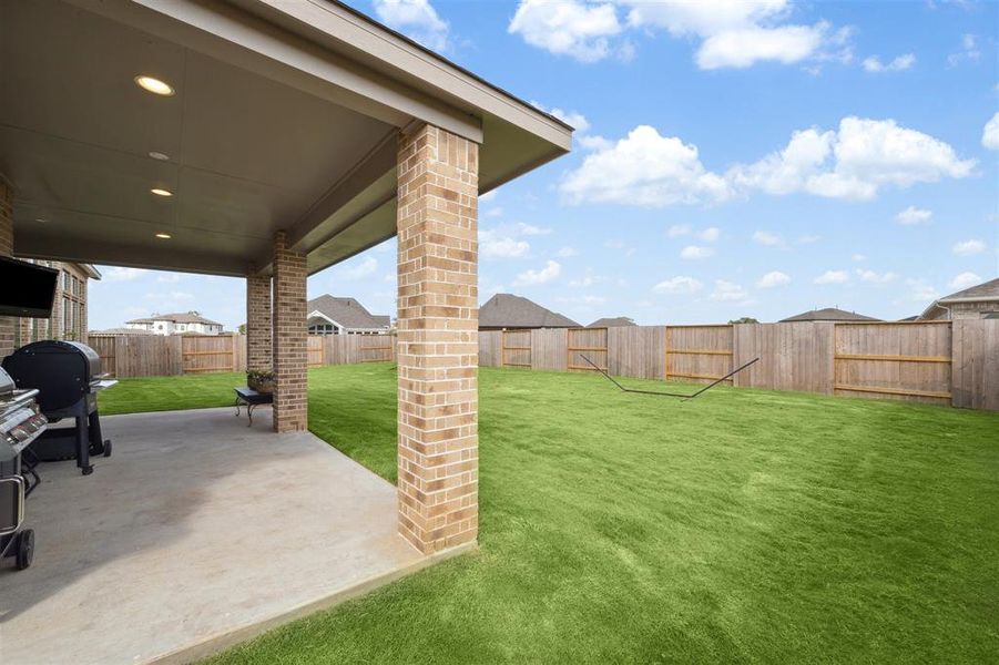 The covered patio is at the right rear of the home and overlooks the backyard.