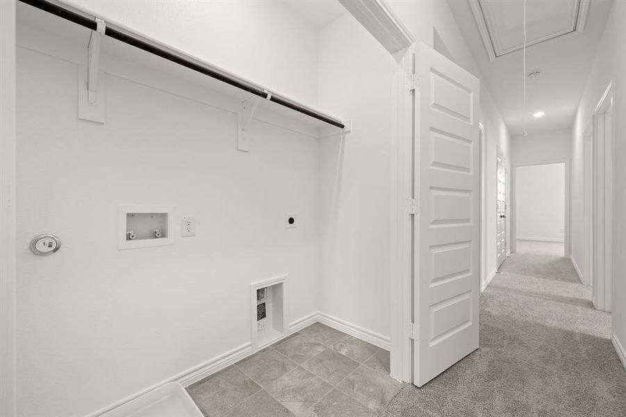 Washroom featuring hookup for a washing machine, hookup for an electric dryer, and light colored carpet