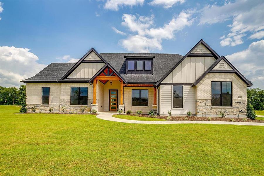 Craftsman-style house featuring a front lawn