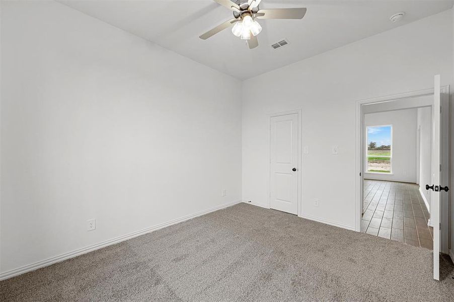 Spare room featuring ceiling fan and carpet floors