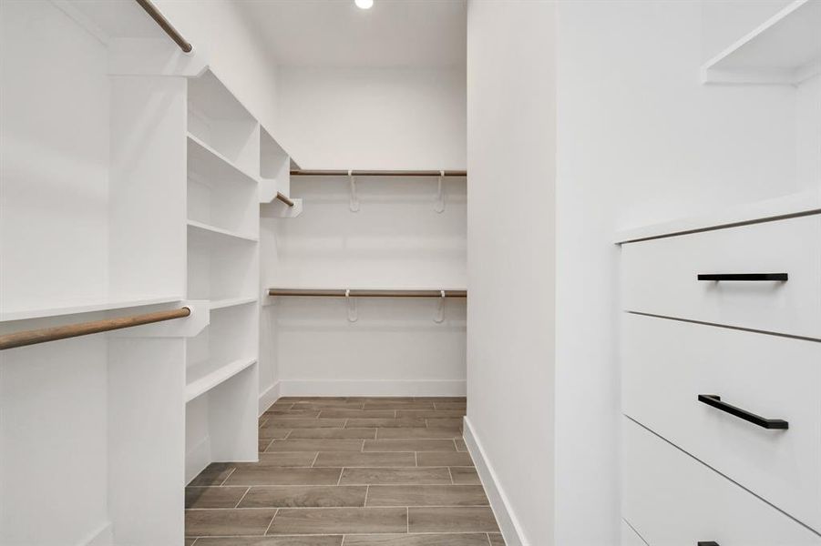 YES! The primary suite offers an oversized walk in closet with custom shelving & drawers.