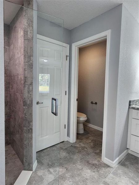 Primary Bathroom with private commode and linen closet