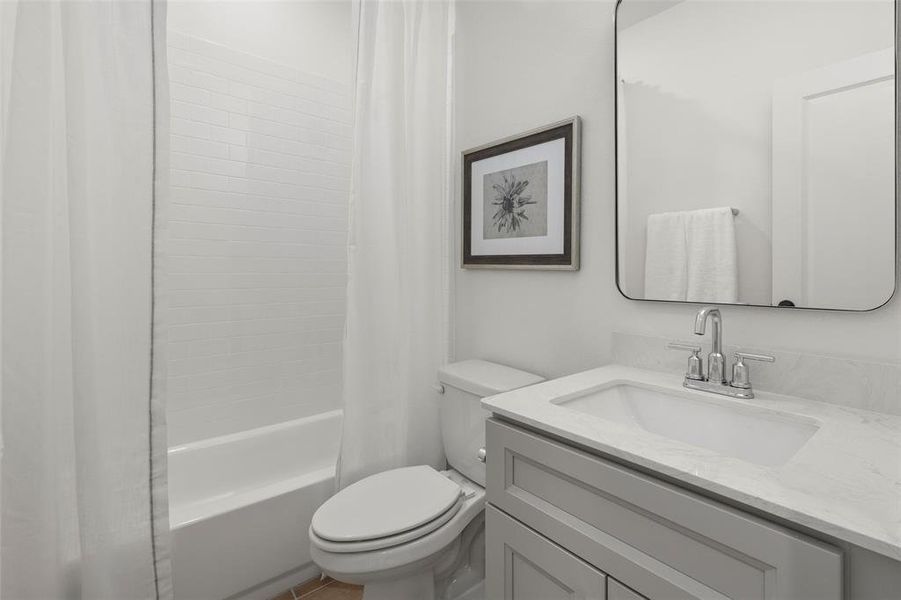 Full bathroom featuring shower / tub combo, large vanity, and toilet