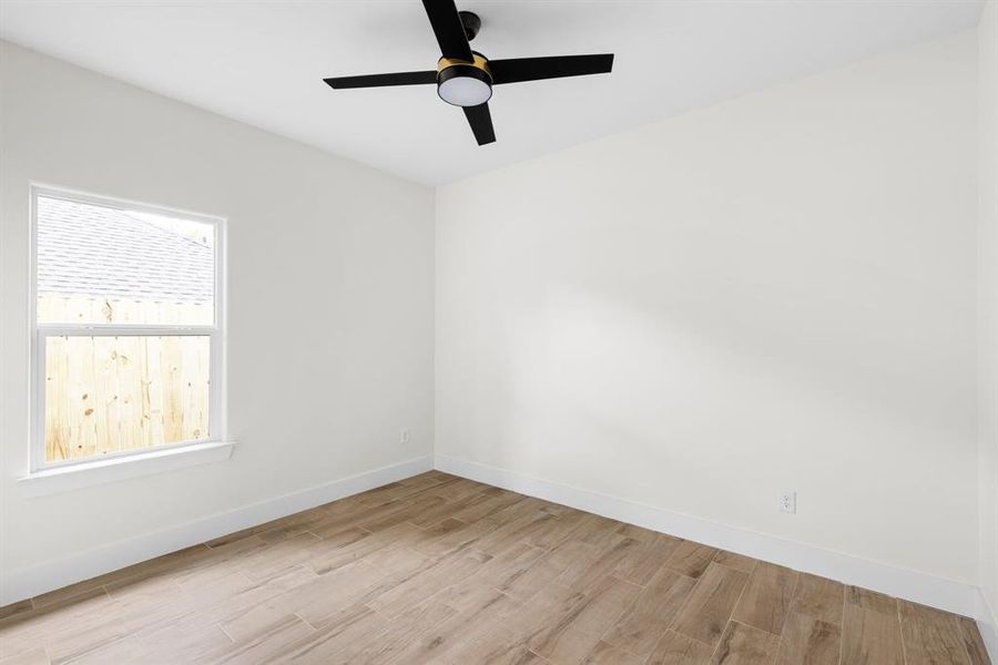 Unfurnished room with ceiling fan and light wood-type flooring