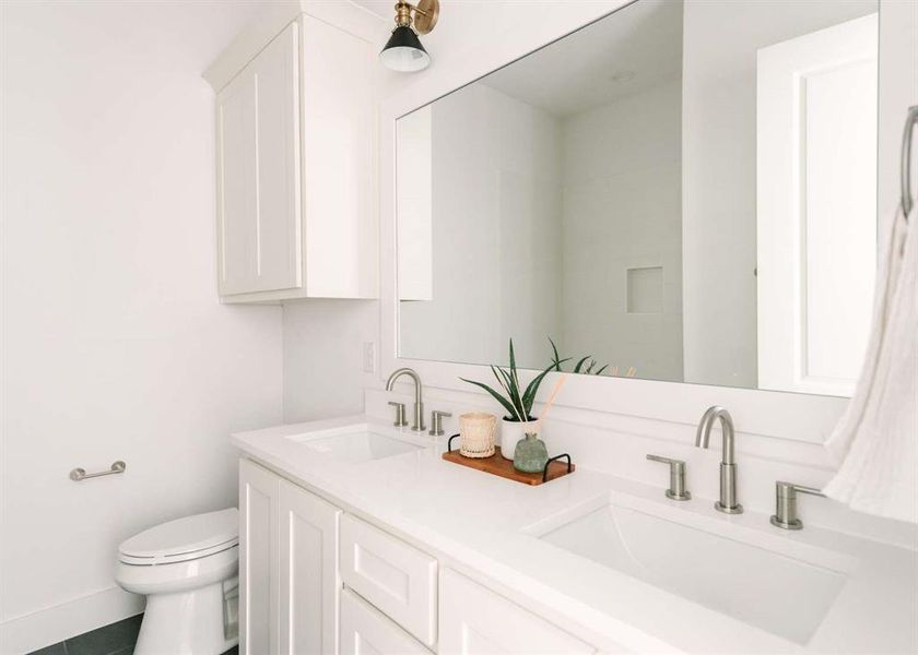 Bathroom with tile patterned flooring, vanity, and toilet