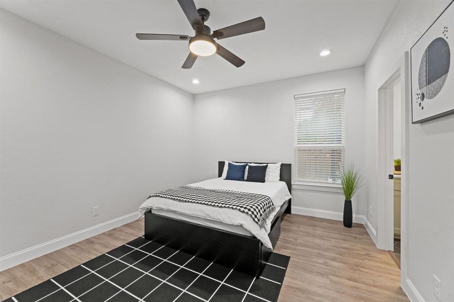 Bedroom with ceiling fan and hardwood / wood-style flooring