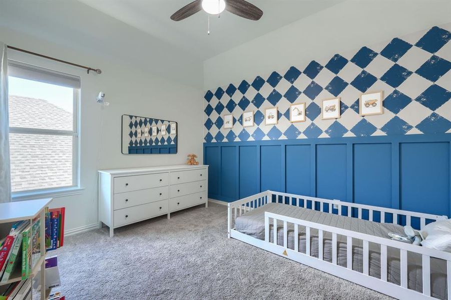 Carpeted bedroom featuring ceiling fan