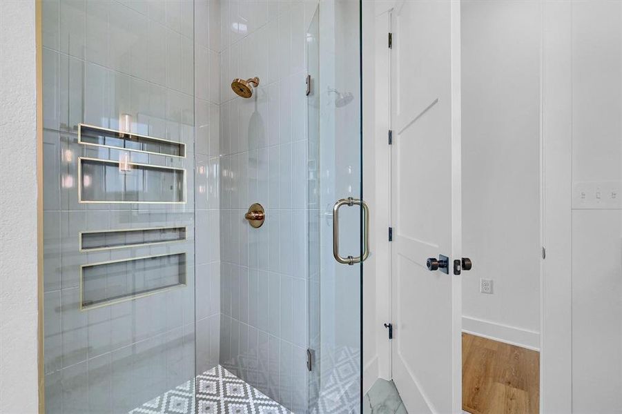 Bathroom with a shower with door and wood-type flooring