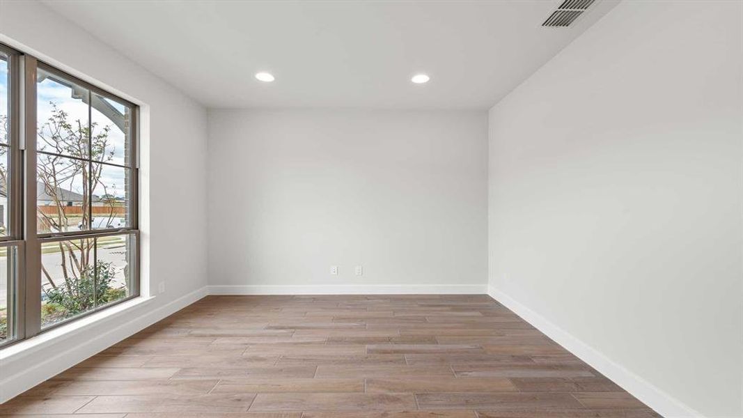 Empty room featuring light hardwood / wood-style flooring and plenty of natural light